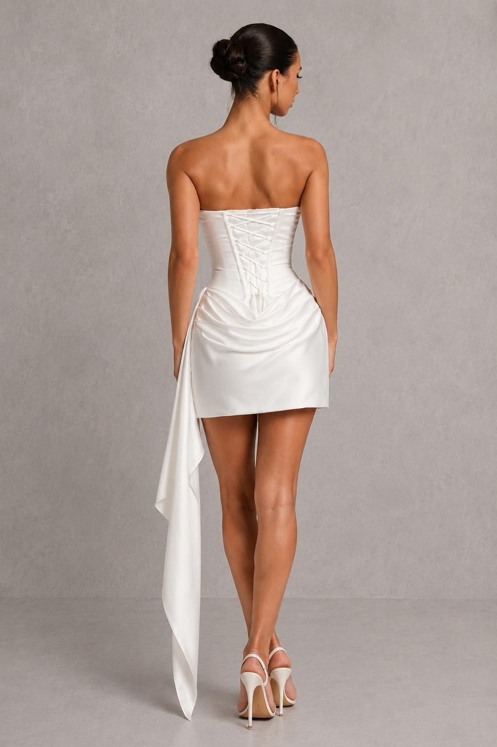 Shop this women's strapless satin mini dress with a corset bodice, cowl neckline, lace-up back, and draped pleated skirt. Perfect for parties, weddings, and special occasions.