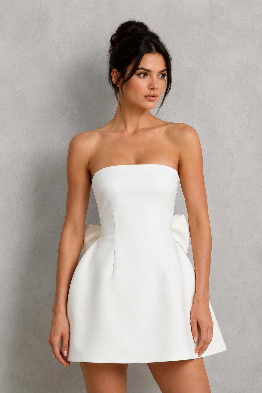 Women's strapless satin mini dress with a structured bodice, voluminous bubble skirt, lace-up back, and oversized detachable bow, designed for parties, weddings, and special occasions.