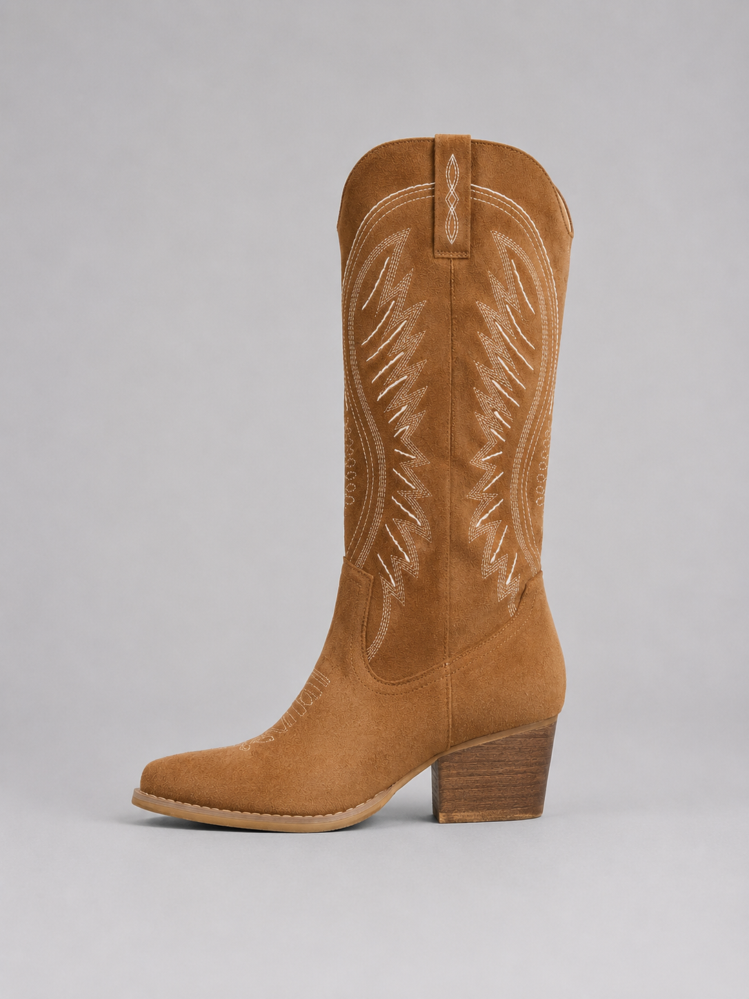 Women’s knee-high suede cowboy boots with western stitching, pointed toe, mid block heel, and classic pull-on design.
