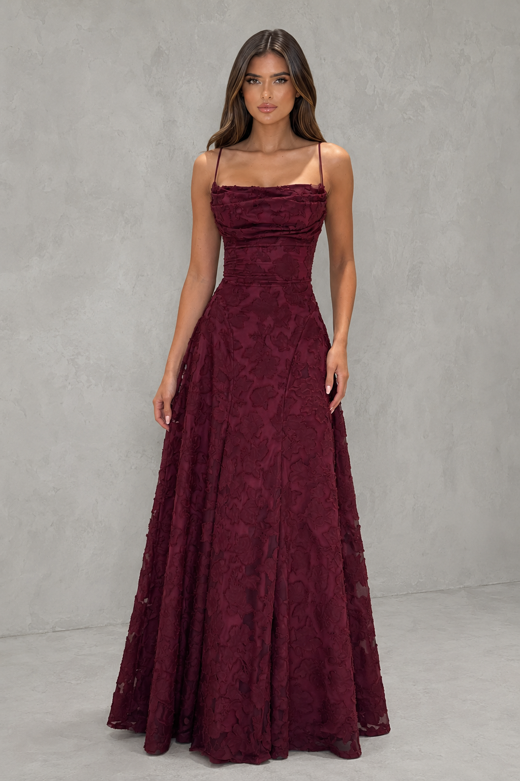 Women’s textured floral maxi dress with delicate shoulder straps, sculpted fitted bodice, defined waist, and flowing full-length skirt.