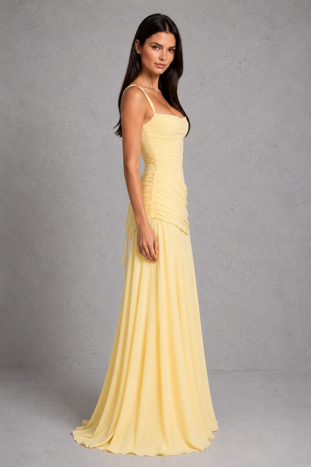 Women’s chiffon maxi dress with a twist cowl neckline, crossover straps, asymmetric pleating, flowing godet skirt and lace-up back.